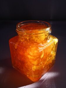 Square jar filled with orange marmalade
