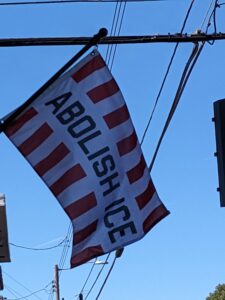 flag that reads "Abolish ICE"